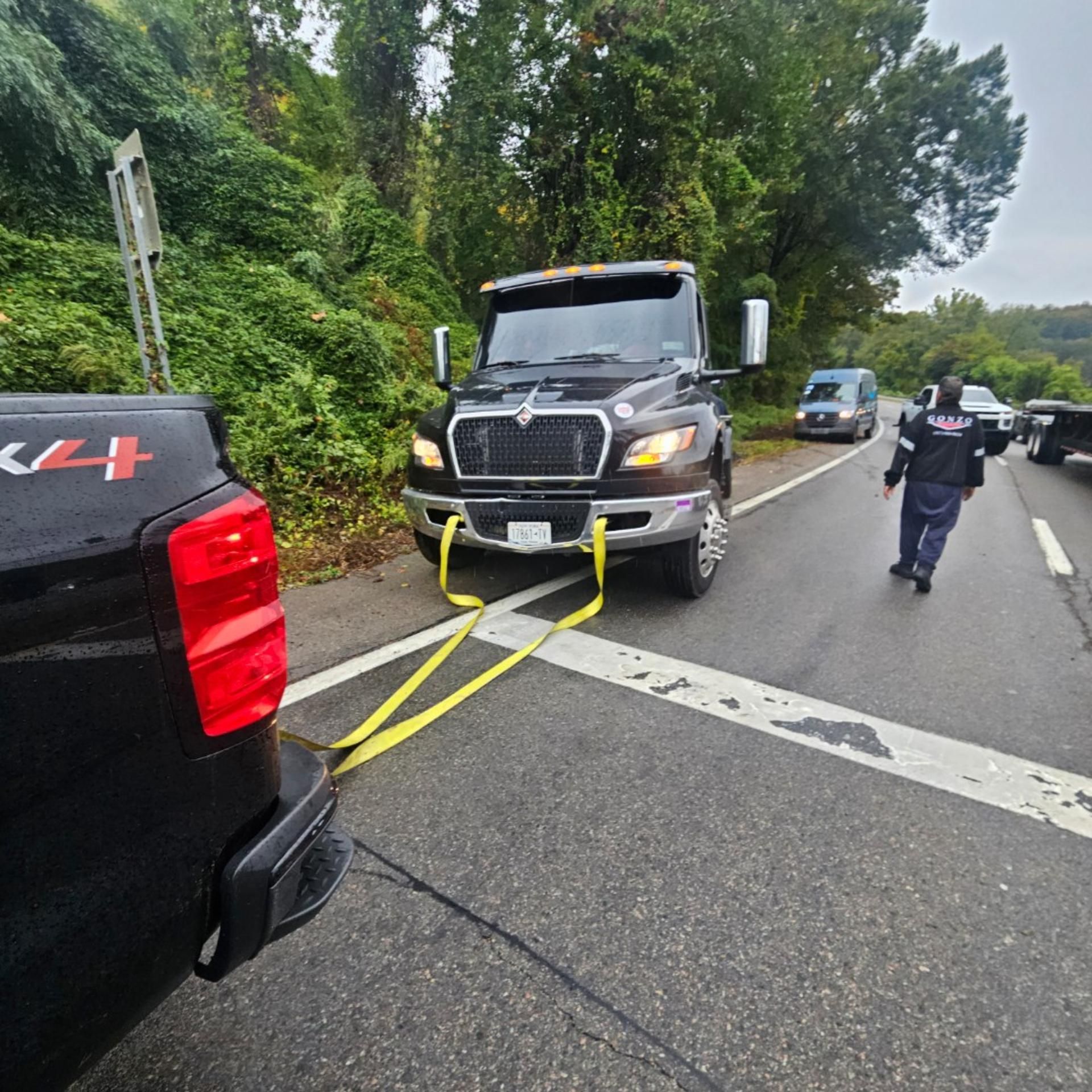 Semi-truck hauling yellow construction equipment on a flatbed trailer. Semi-truck hauling yellow construction equipment on a flatbed trailer.
