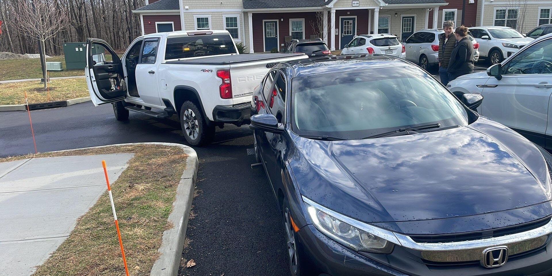 Car tire with chain lock, preventing movement. Silver wheel, black tire, gray chain. Car tire with chain lock, preventing movement. Silver wheel, black tire, gray chain.