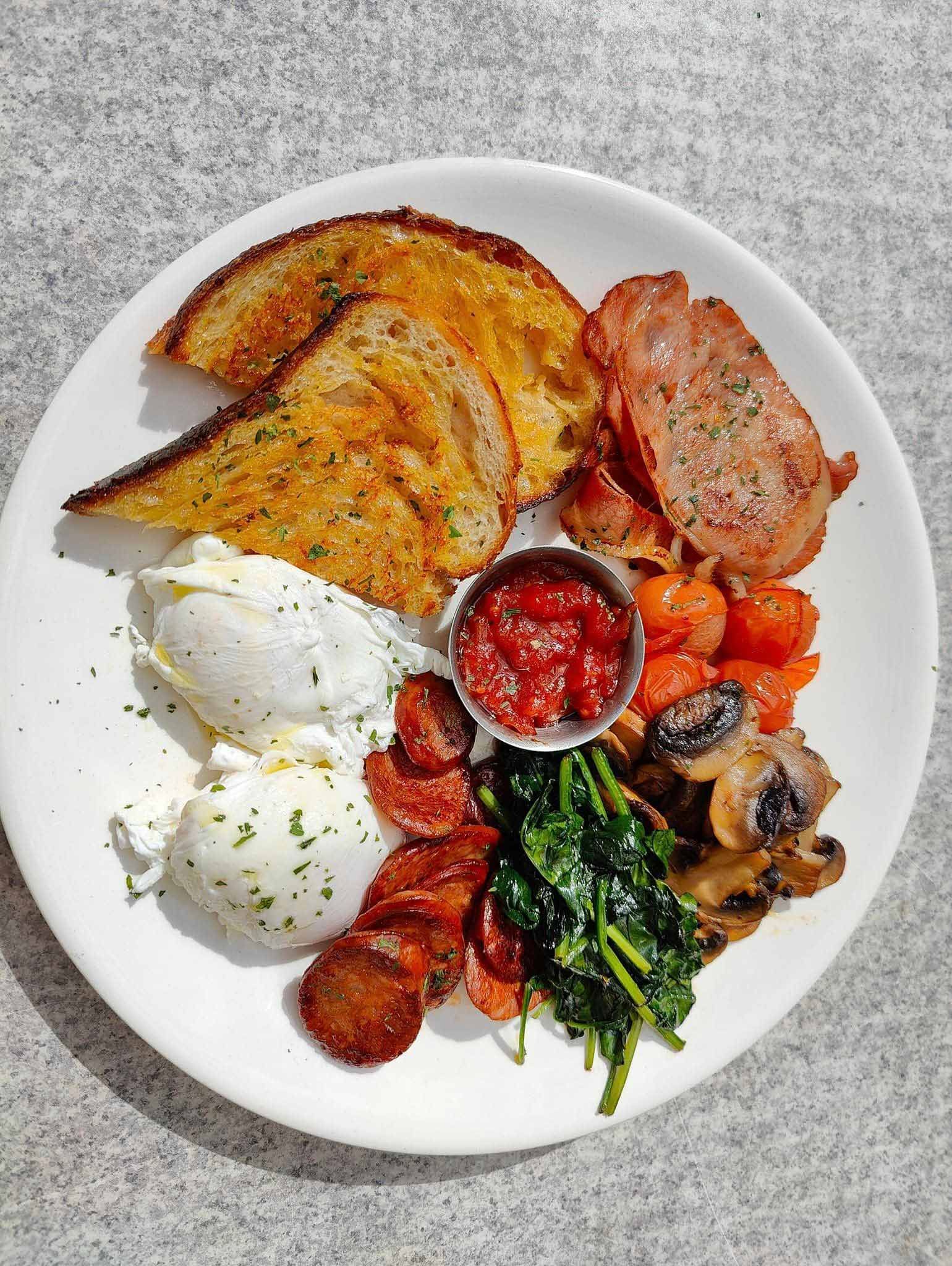 a white plate topped with a variety of food on a table .