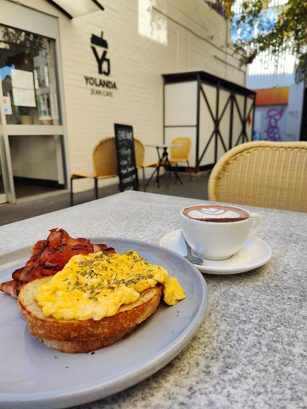 a plate of food sits on a table outside of a restaurant