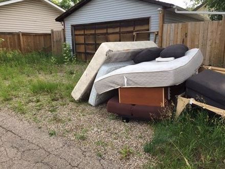a house with a lot of trash in front of it .