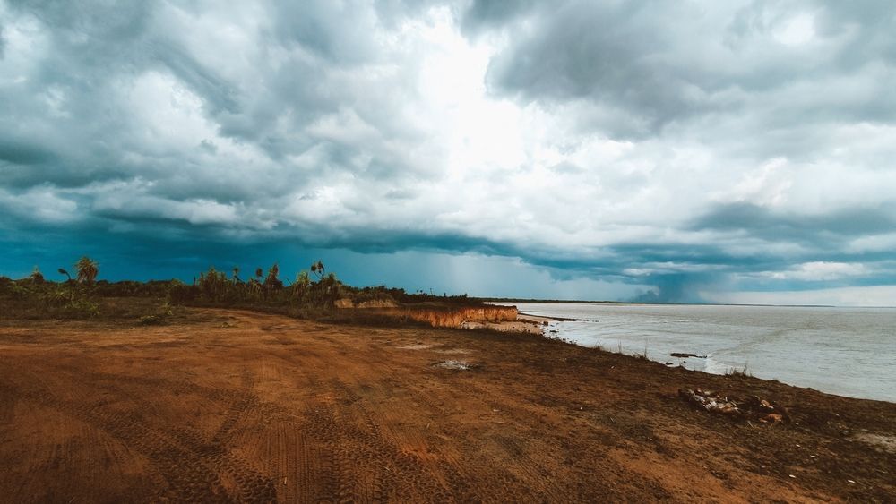 Scenic View of Dirt Field Alongside Water Body With Sky in Background at Dundee Beach — Coleman's Contracting & Earthmoving In Dundee Beach, NT