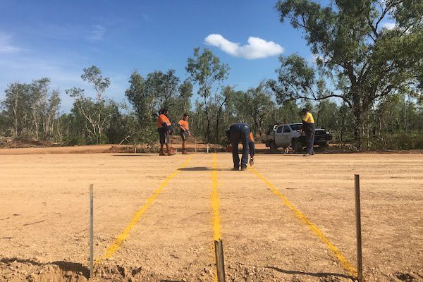A Team Of Individuals Is Marking On A Gravel Path With Yellow Lines — Coleman's Contracting & Earthmoving In Humpty Doo, NT
