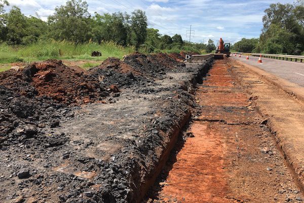 A Large Pile Of Dirt Is Laying On The Side Of A Road For Water Management — Coleman's Contracting & Earthmoving In Humpty Doo, NT