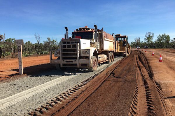 Large Truck With An Excavator Constructing The Road — Coleman's Contracting & Earthmoving In Humpty Doo, NT