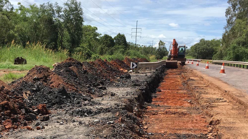 A Large Pile Of Dirt Is Laying On The Side Of A Road For Water Management — Coleman's Contracting & Earthmoving In Katherine, NT