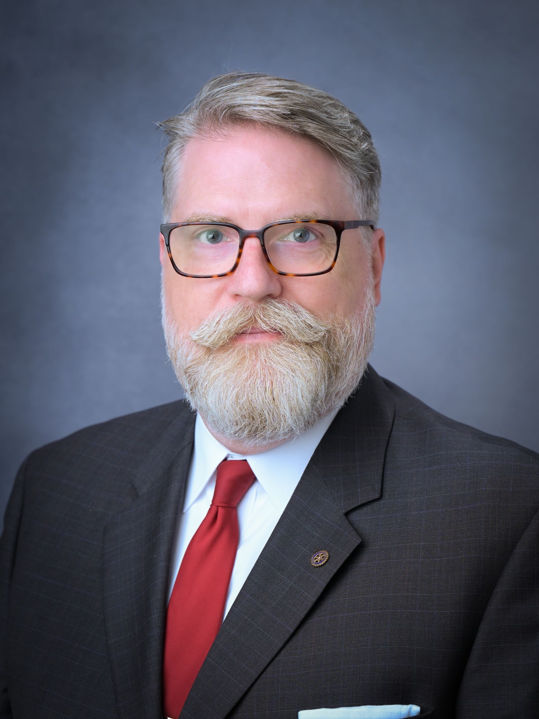 Wooden gavel on a block, on a wooden surface.