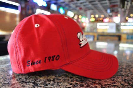 A bright red baseball cap with 