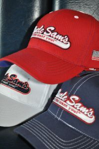 Three baseball caps in red, white, and blue, each embroidered with the 