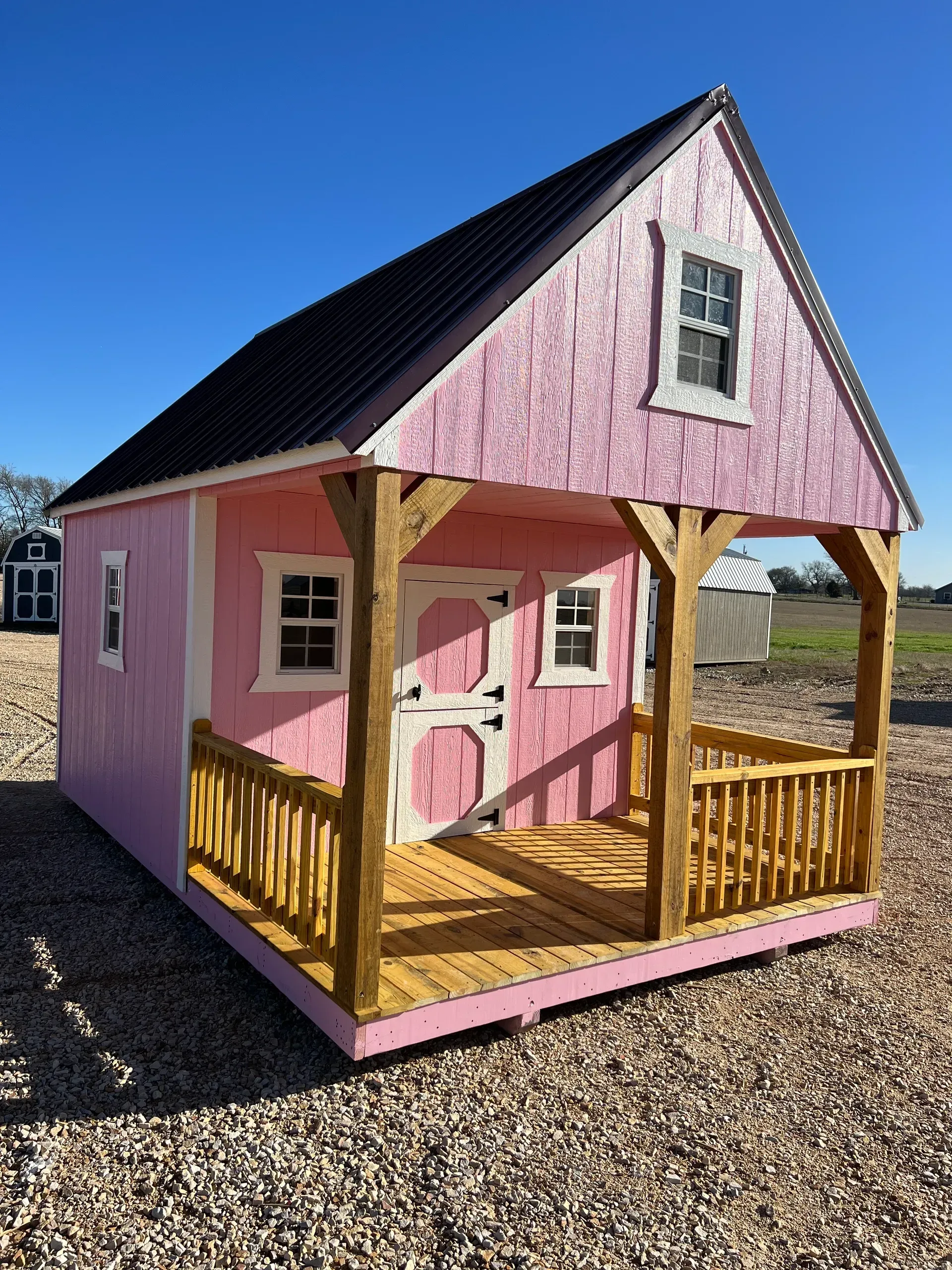 pink playhouse with porch