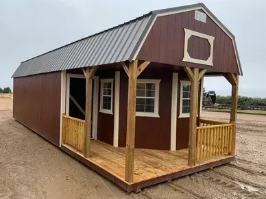 brown lofted cabin with porch