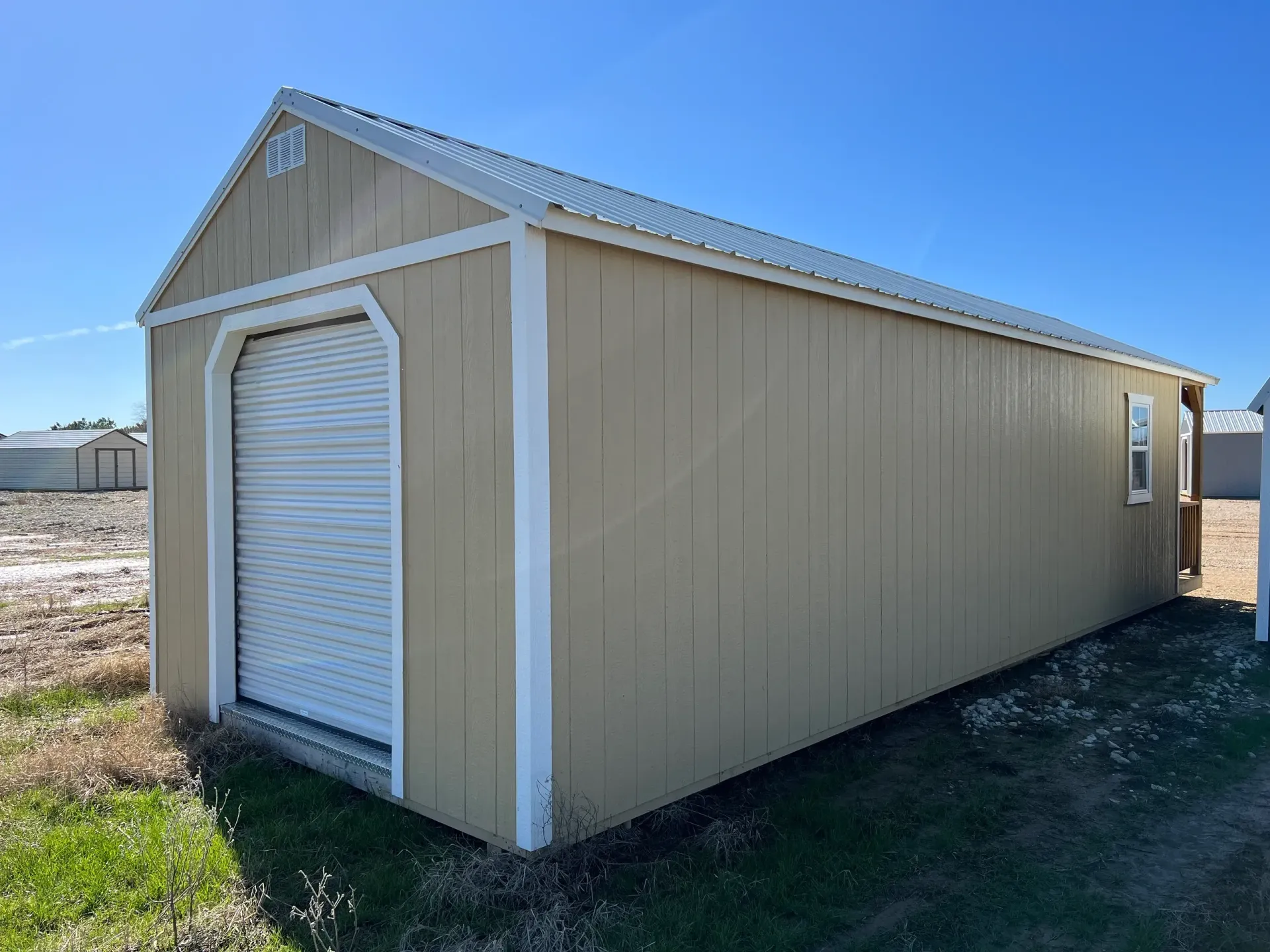 long tan shed with roll up door