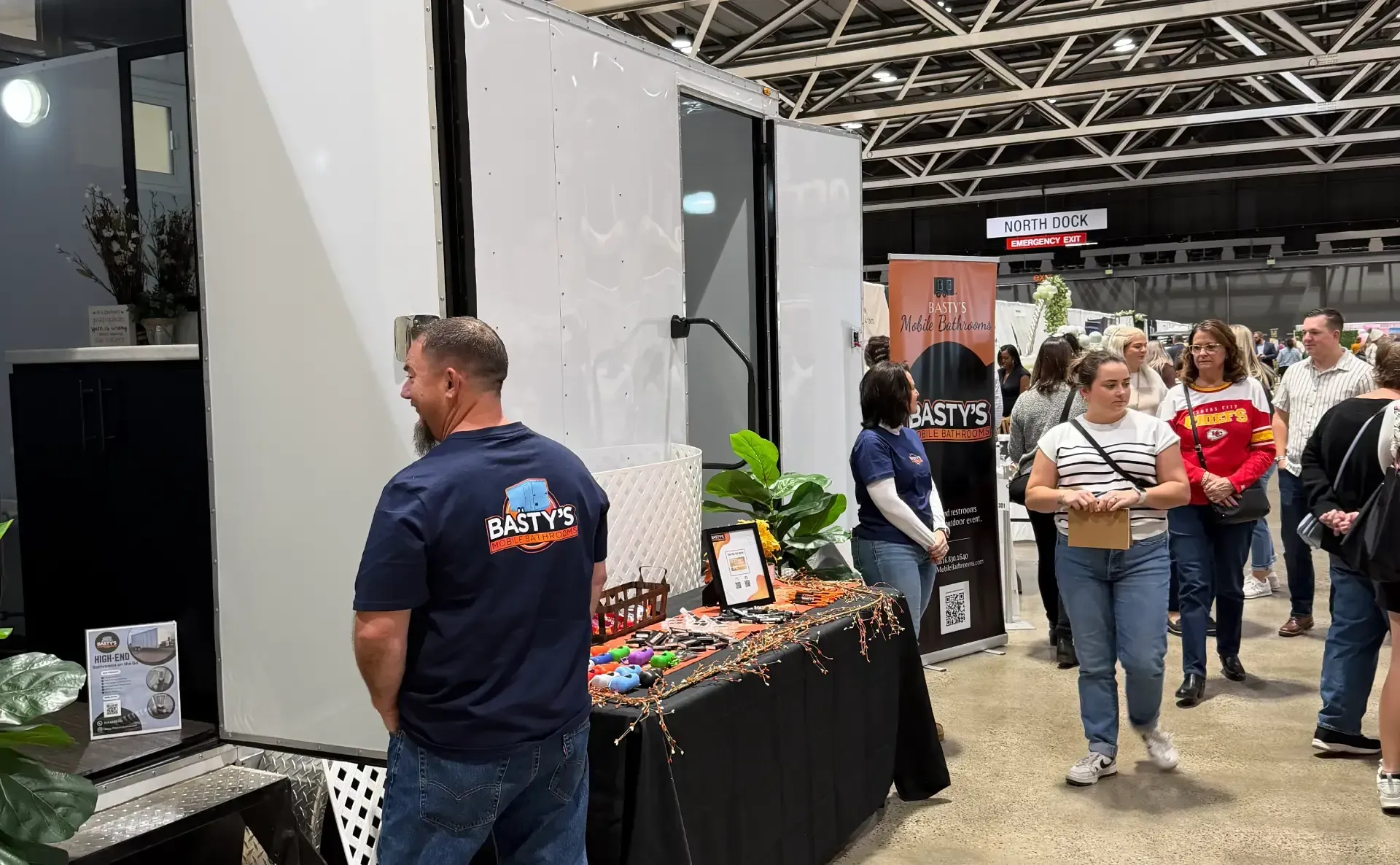 A group of people gathered around a table inside a spacious indoor venue