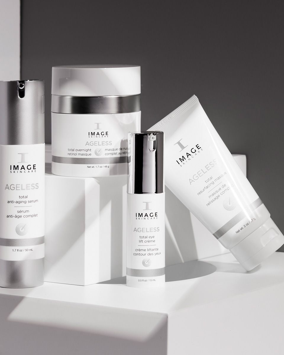 Various Image Skincare anti-aging skincare products, white and silver, on a white surface.