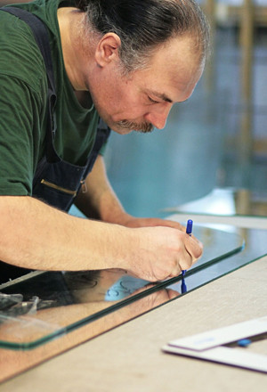 man cutting glass