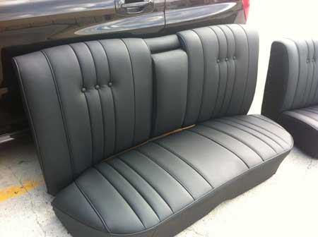 black car seat with folding armrest