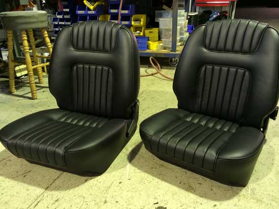 two single black padded car seats
