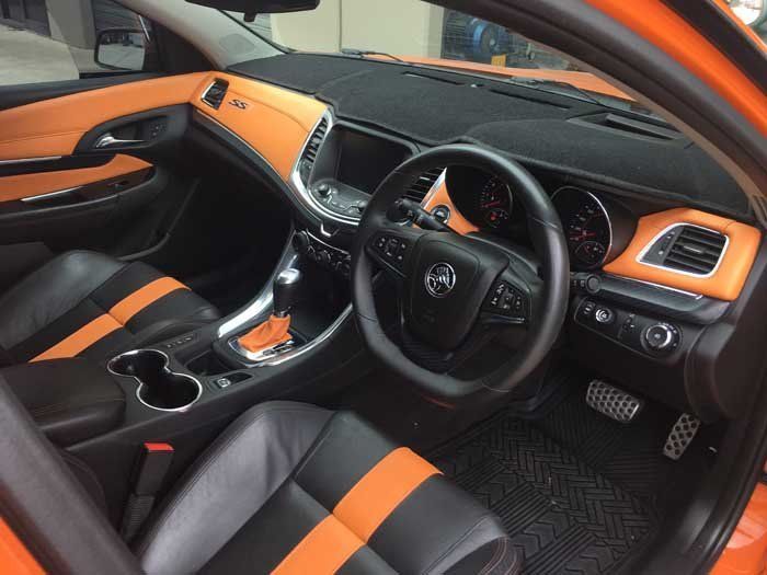 black steering wheel with black and orange striped seats