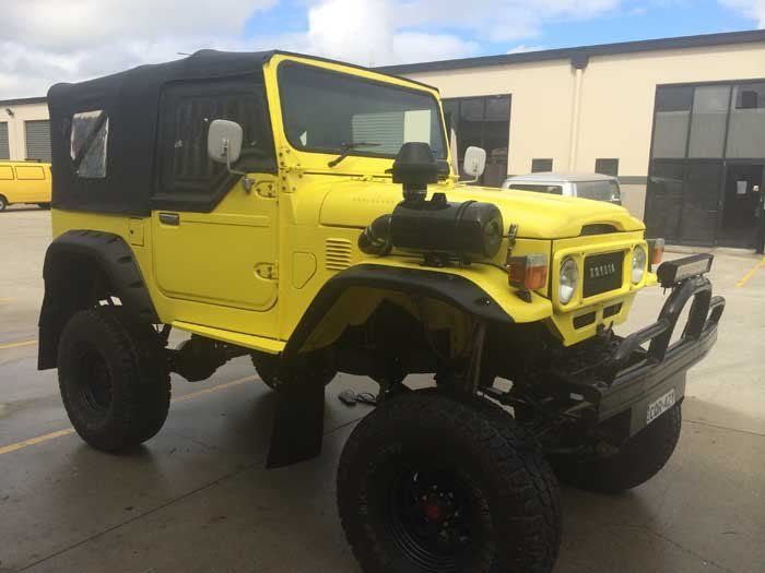 yellow jeep with large tires