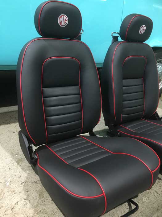 two black car seats with red lines