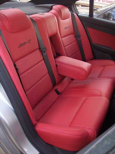 two red car seats with arm rest