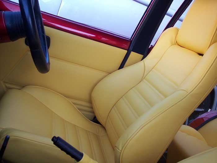 tan driver seat with a black steering wheel
