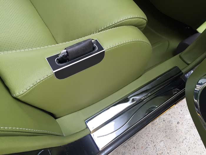 green seat with a black seat belt