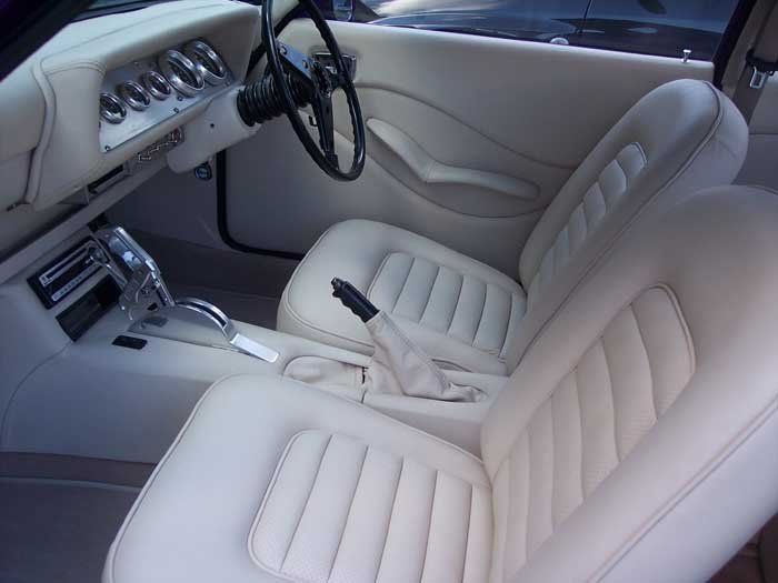 white car seats with a black steering wheel
