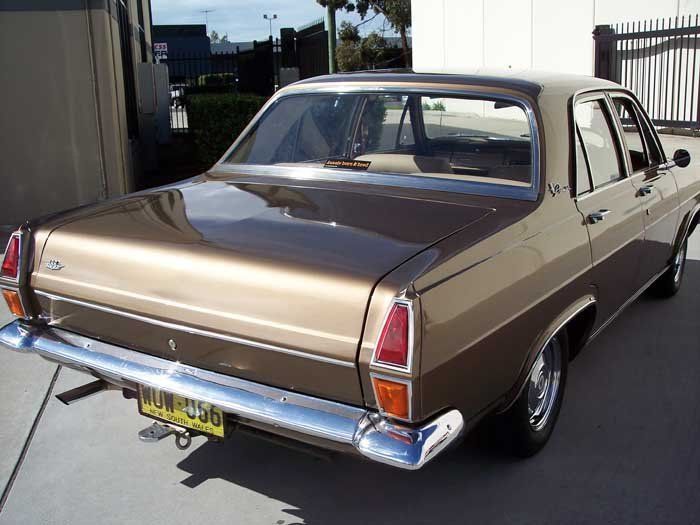a back view of a brown and gold car