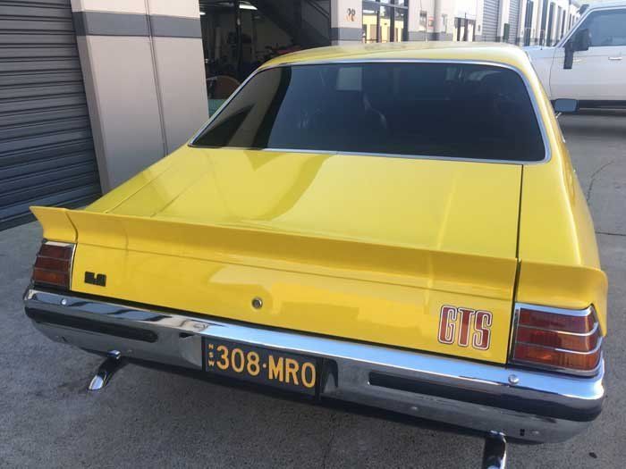 the back of a yellow car