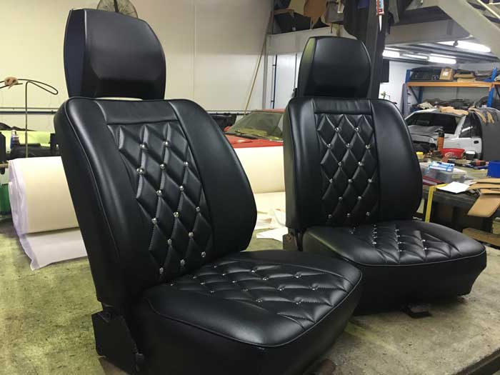 two new black padded car seats