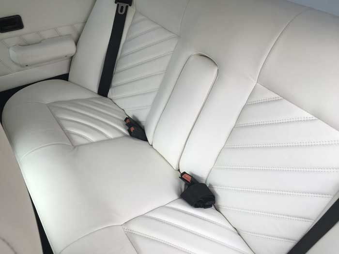 two back seats with black seat belts