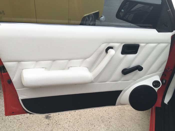 a white car door with black handles