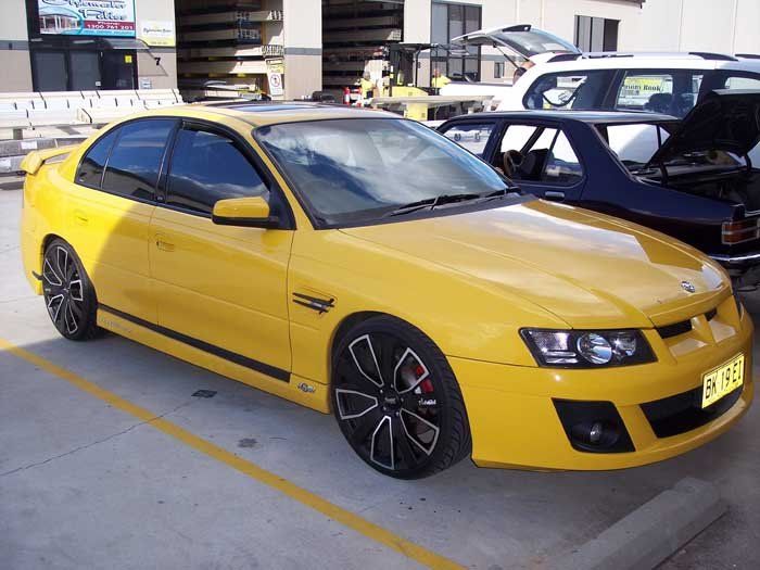 a yellow car with a small black stripe
