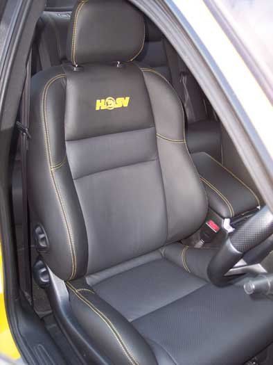 black seat with yellow logo on it