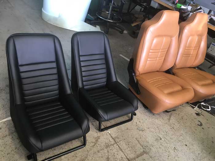 brown car seats next to black car seats