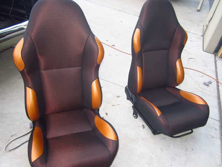 two orange tipped car seats
