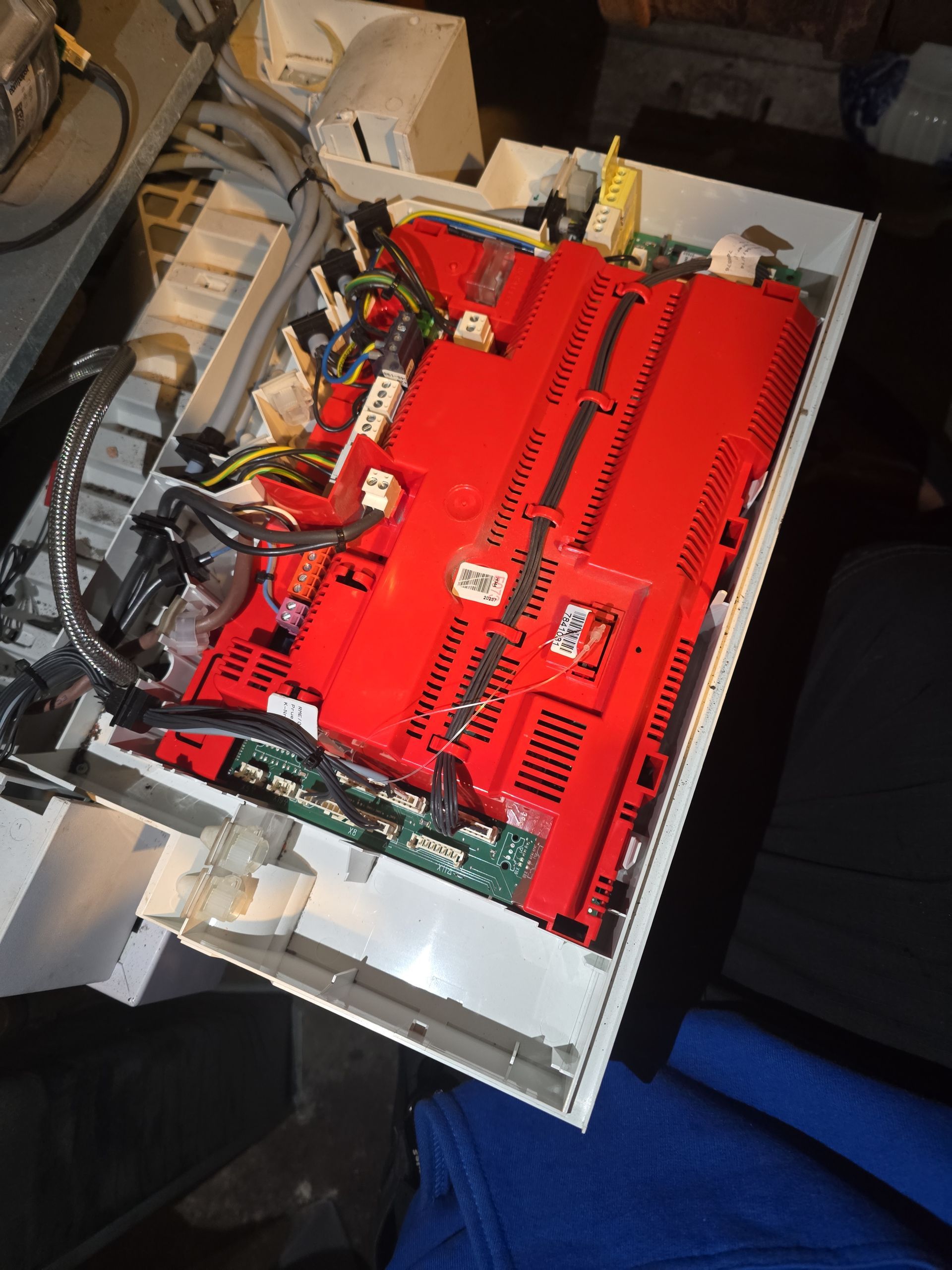 Open control panel with red circuit boards and wiring.