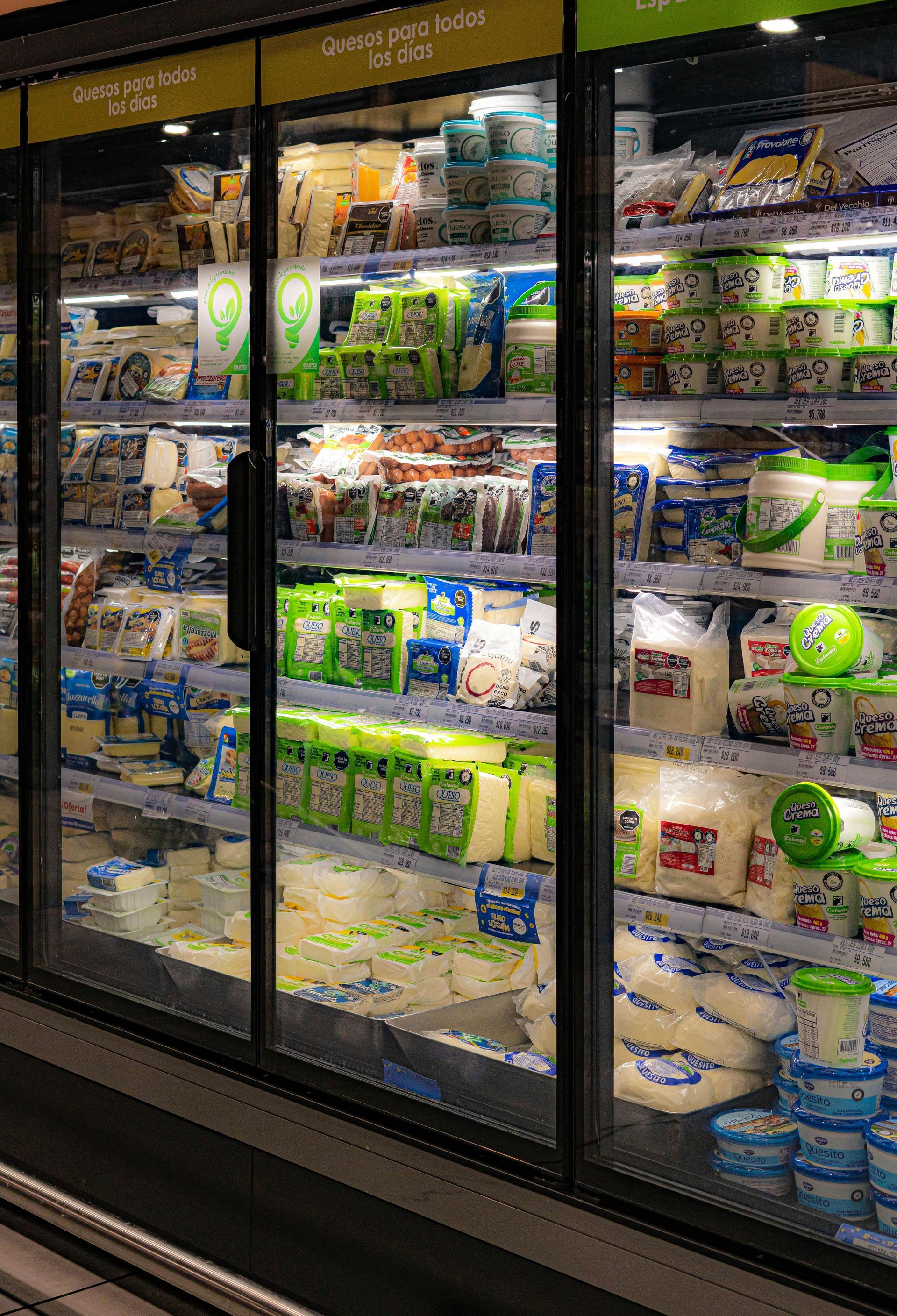 Dairy case in a grocery store, full of yogurt, milk, and cheese products.