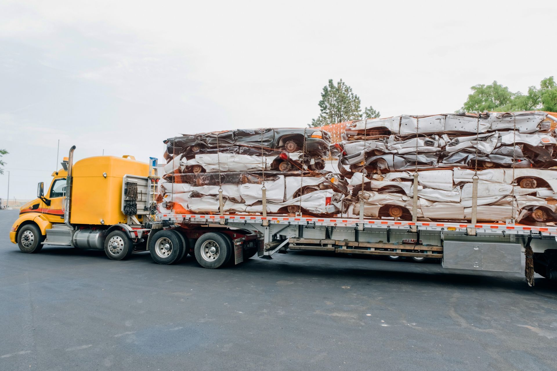 A semi-truck transporting multiple cars on a flatbed, showcasing efficient transportation services. A semi-truck transporting multiple cars on a flatbed, showcasing efficient transportation services.