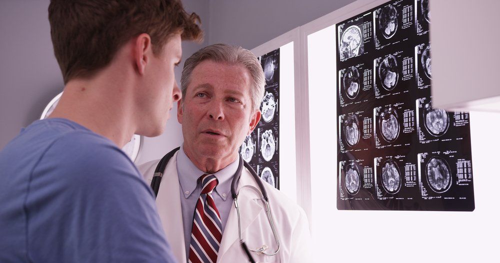 doctor and patient looking at brain scans