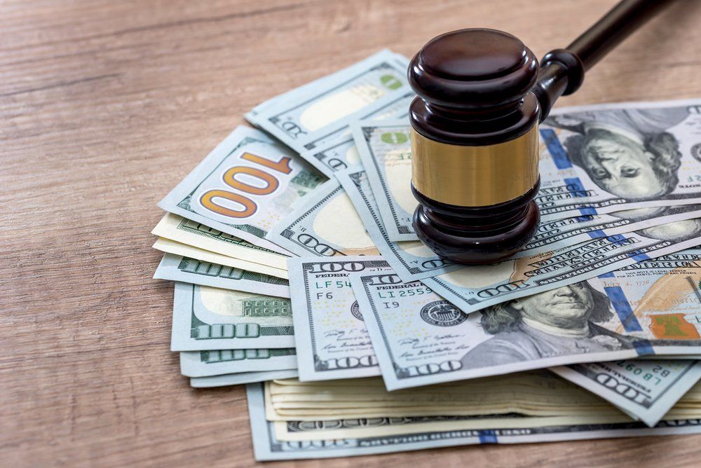 Gavel on top of stack of money