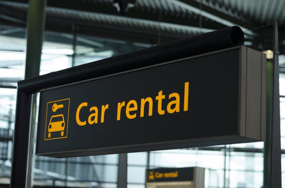 sign of car rental area at airport
