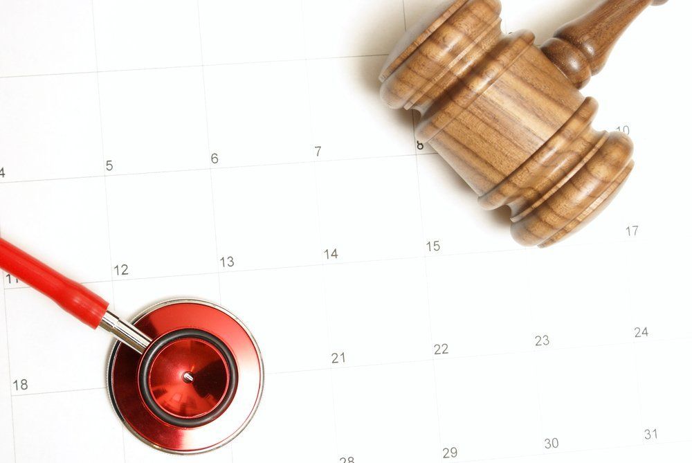 stethoscope and gavel on top of a calendar