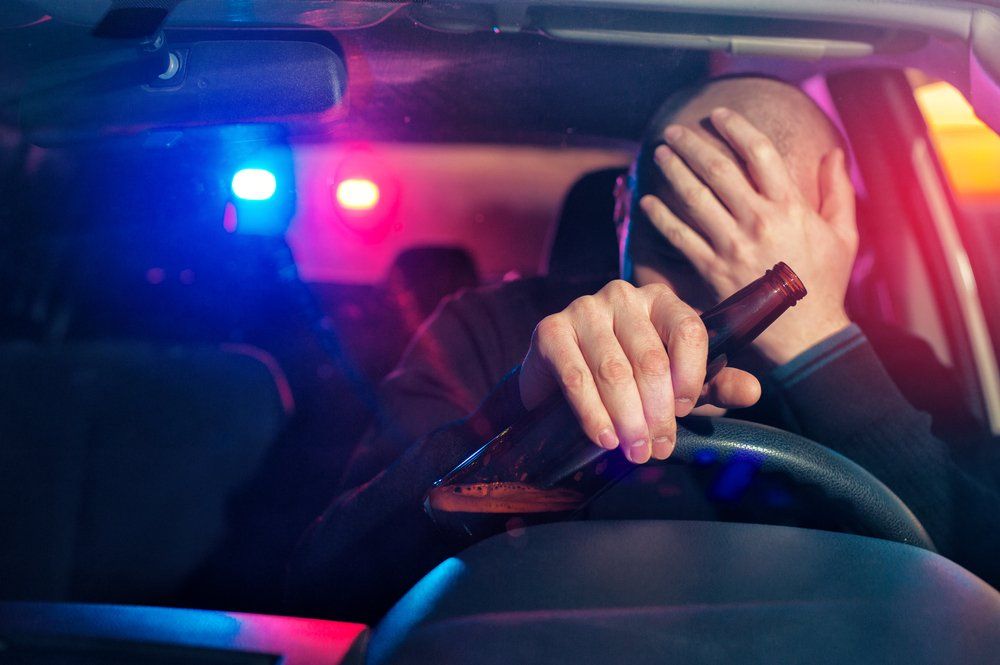 man with beer bottle in hand upset that he got pulled over