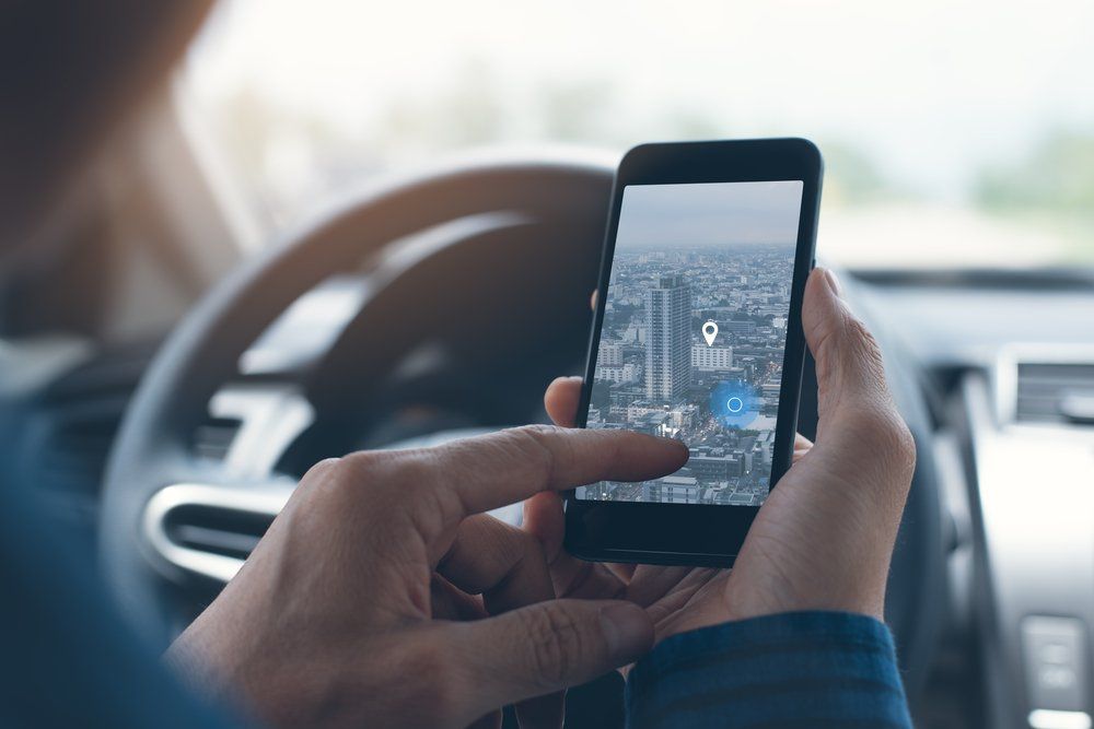 driver of a car using gps on their phone 