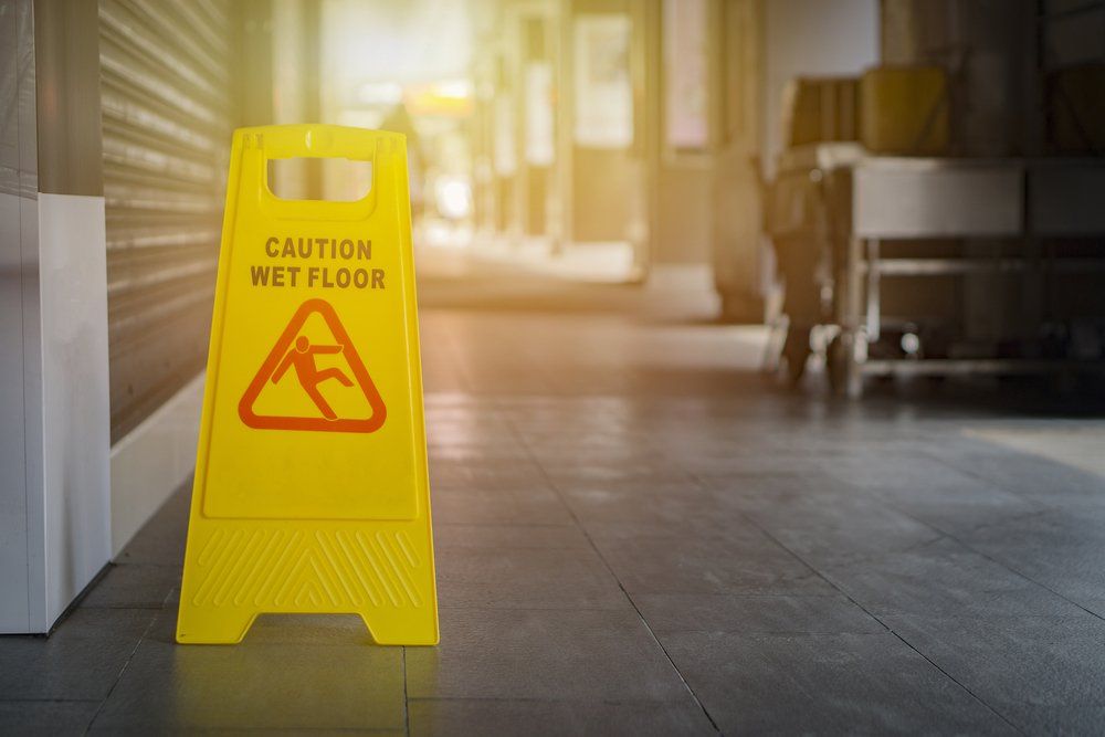 wet floor sign on the ground in a hospital hallway