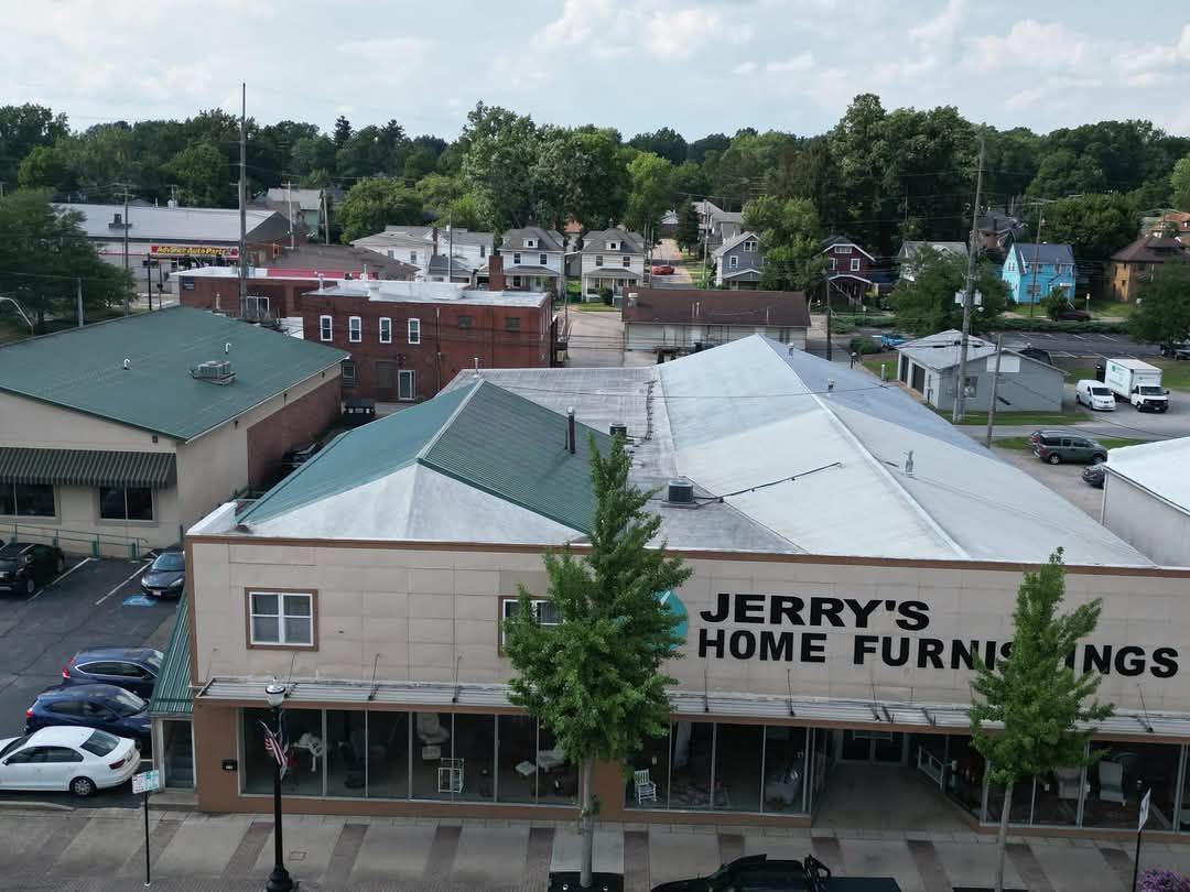 Aerial view of Jerry's Home Furnishings store with surrounding buildings and trees.