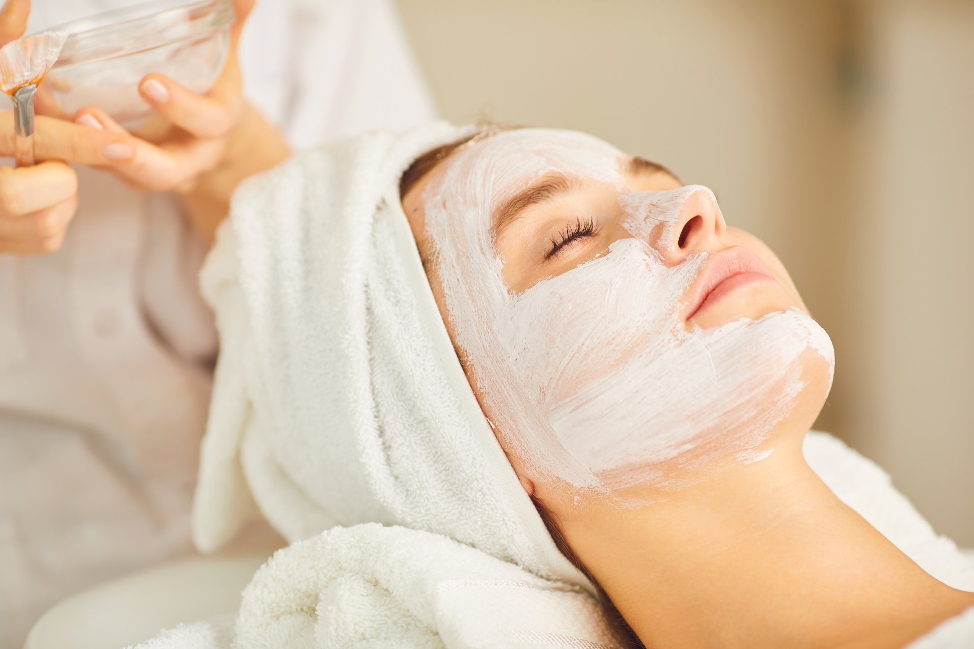 A woman is getting a facial at a spa.