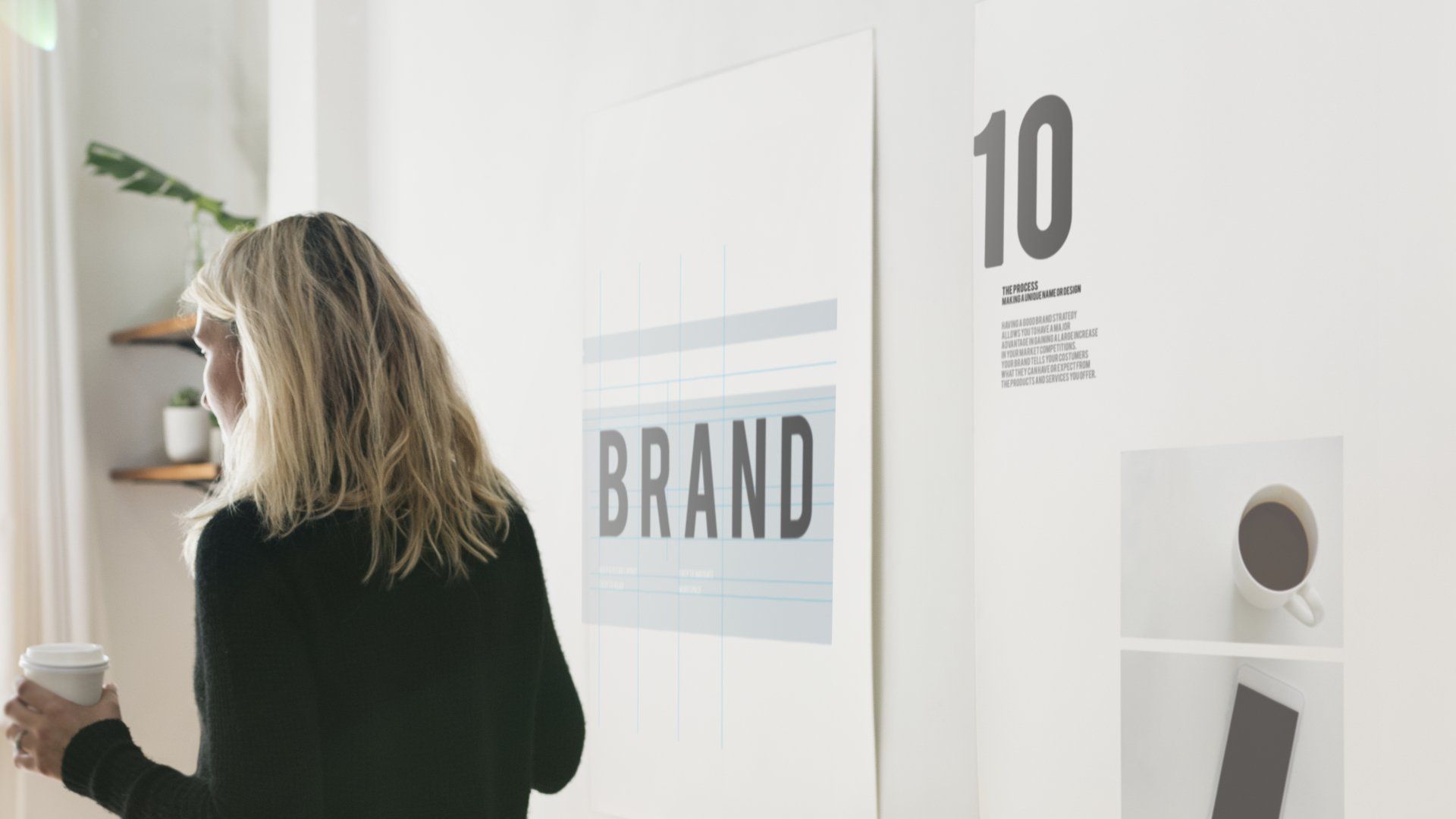 A woman is standing in front of a sign that says brand.